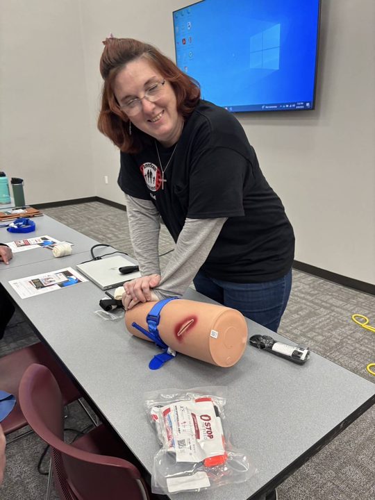 A volunteer practises wound packing on a training model during a Stop the Bleed class
